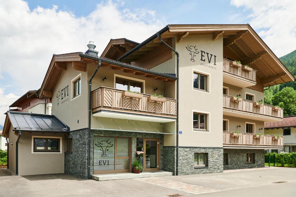 a building with a balcony on top of it at EVI APARTMENTS via we rent in Kaprun