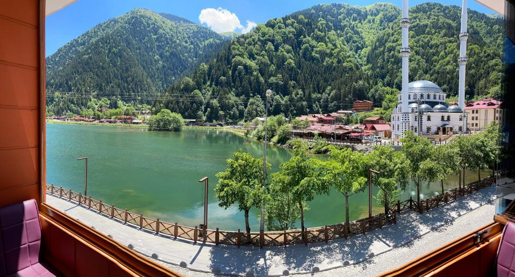 a view of a lake from a window at Osmanlı Suite in Uzungöl