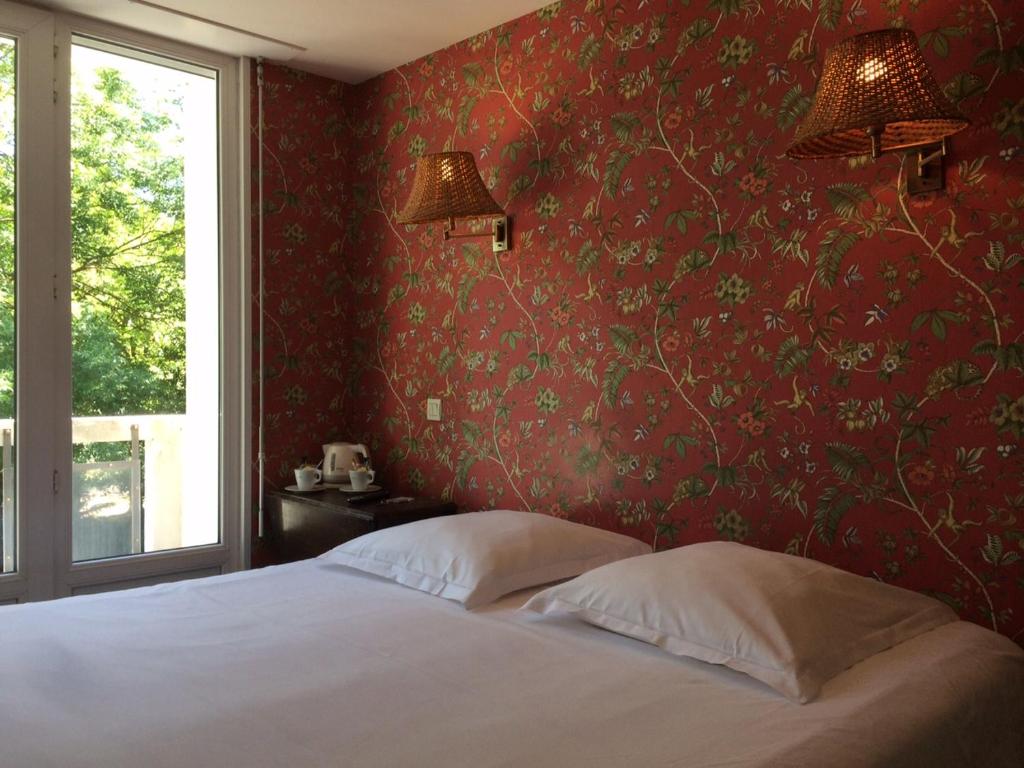 Postel nebo postele na pokoji v ubytování Hotel Richelieu