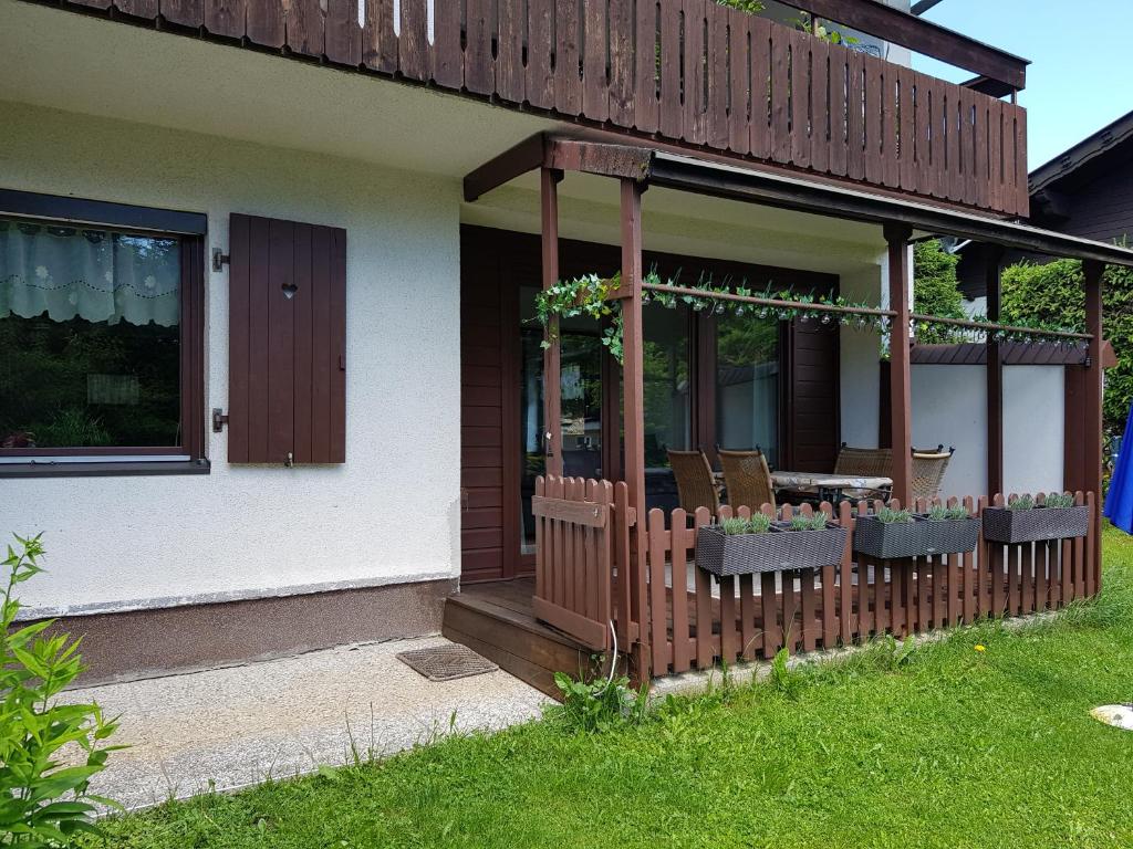 Casa con porche con mesa y sillas en Ferienwohnung Greilitz beim Forstsee, en Techelsberg am Worthersee