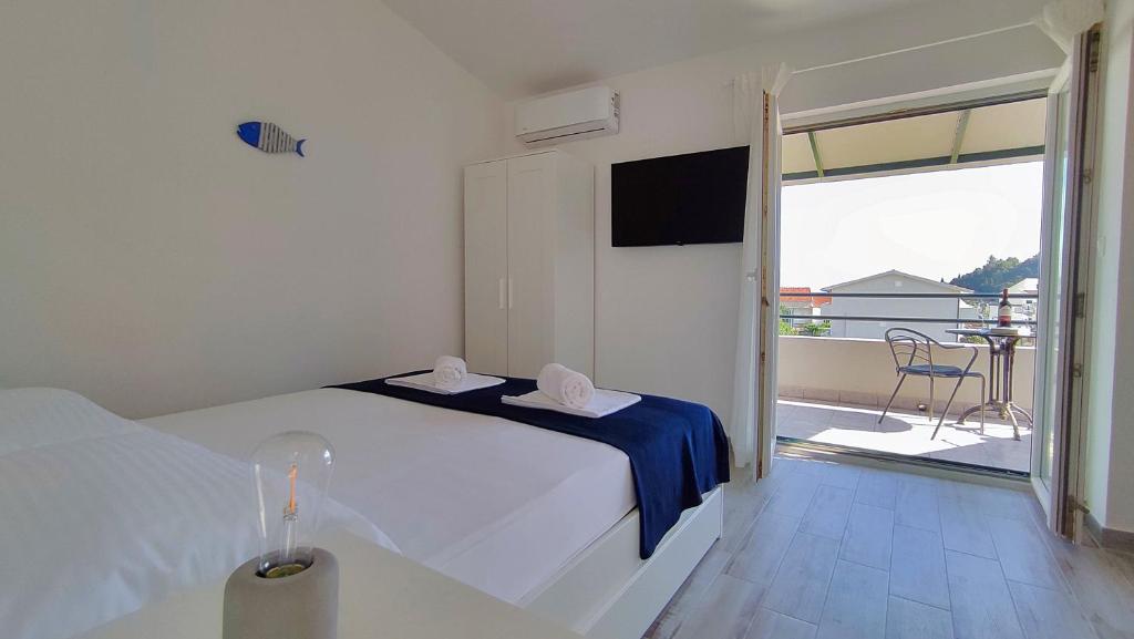 Postel nebo postele na pokoji v ubytování Apartmani Bodo