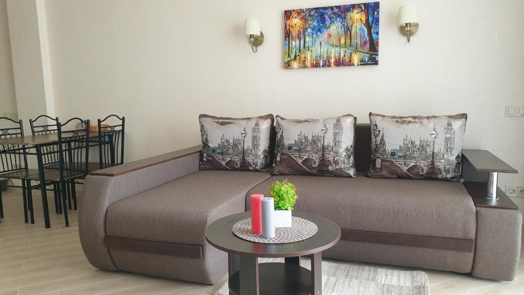 a living room with a couch and a table at Грибовка,Морской Аромат in Gribovka