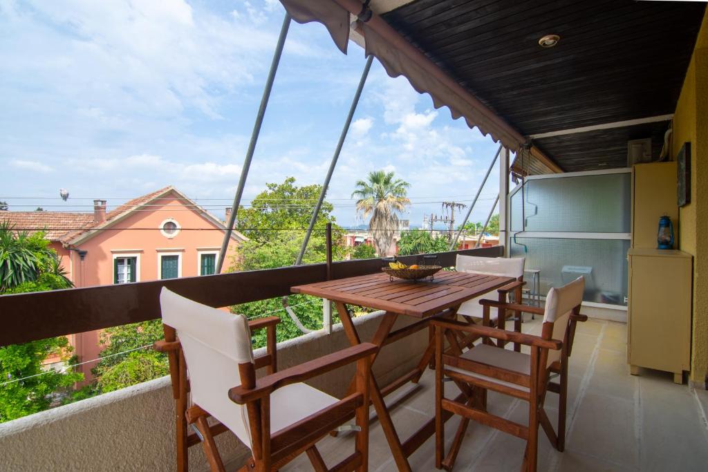 a balcony with a wooden table and chairs at Stellas apartment in Análipsis