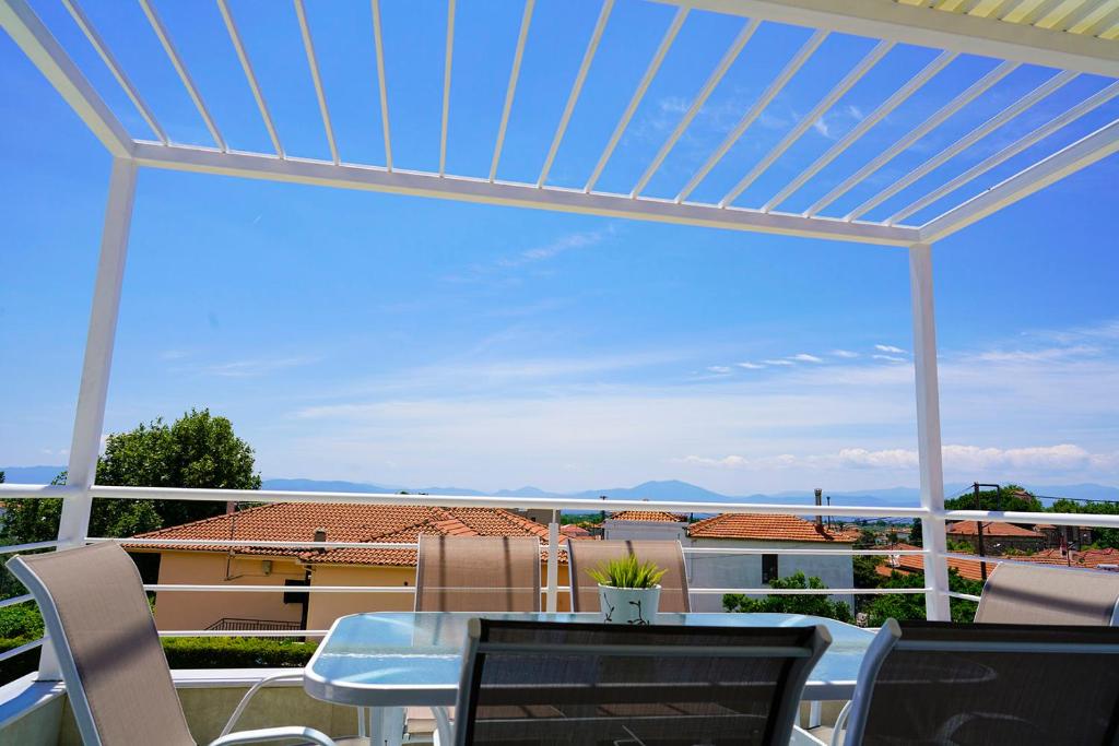 a patio with a table and a view of a building at Charikleia's 1st floor appartment in Pelion in Volos