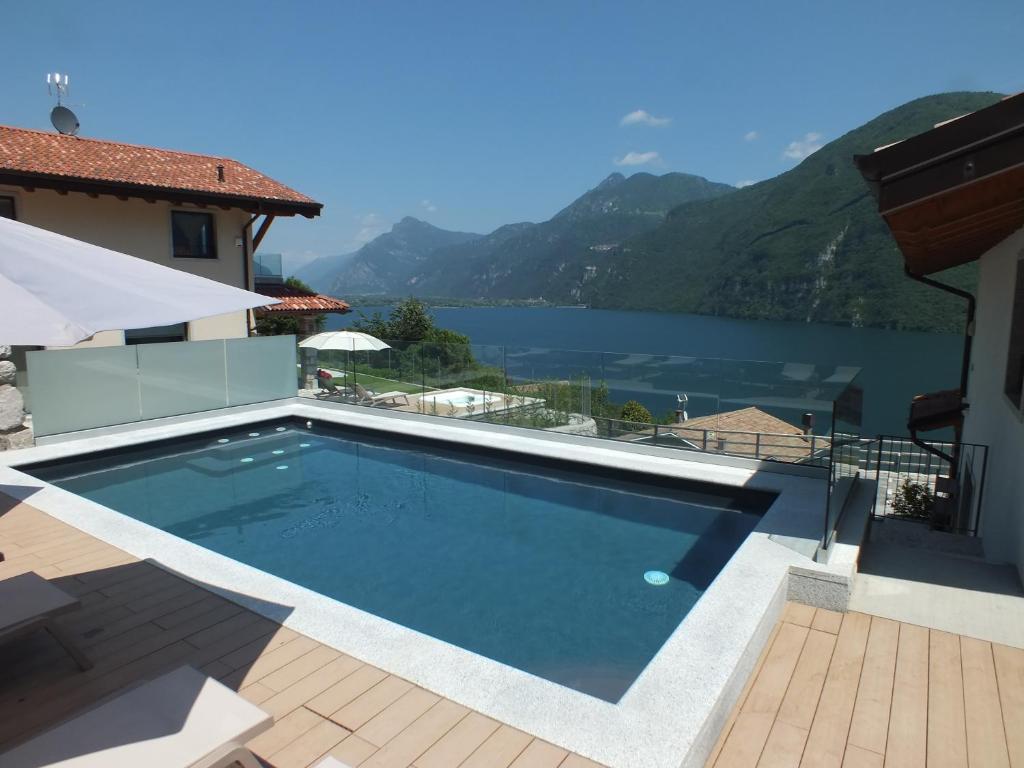 a swimming pool with a view of a lake at Rocca d'Anfo B&B-Apartments Lake View in Rocca dʼAnfo