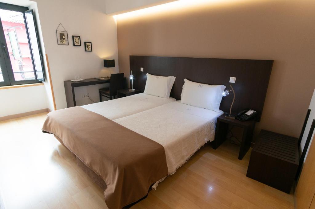 Кровать или кровати в номере Hotel Vitória