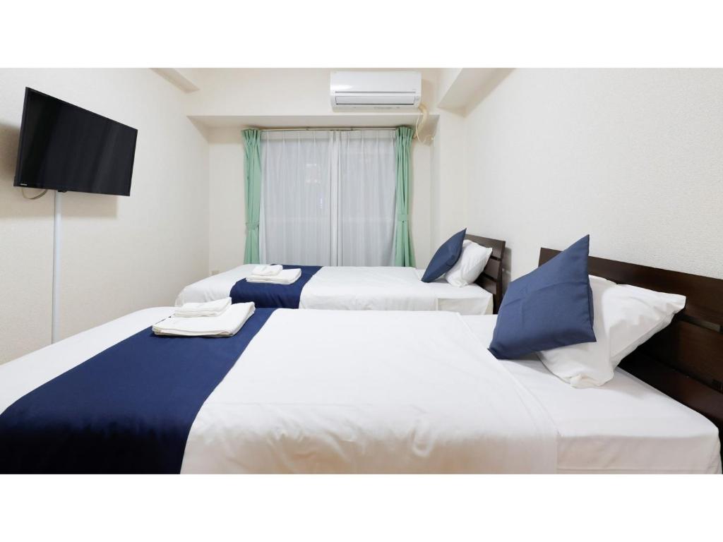 A bed or beds in a room at HOTEL Nishikawaguchi Weekly - Vacation STAY 44769v