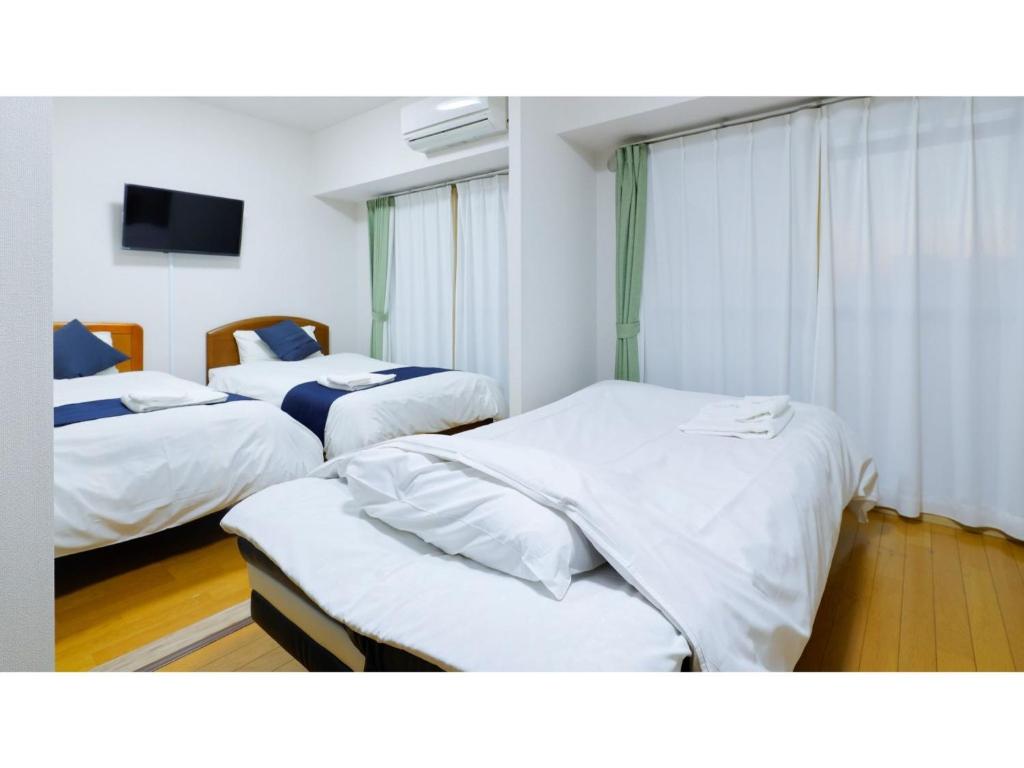 Łóżko lub łóżka w pokoju w obiekcie HOTEL Nishikawaguchi Weekly - Vacation STAY 44772v