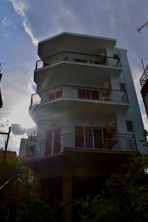 a building with two dogs sitting on the balconies at Bob's Apartments in Tolo