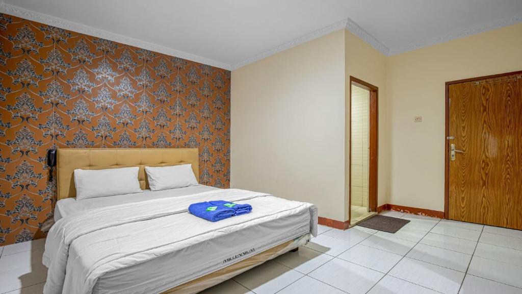 Postel nebo postele na pokoji v ubytování Hotel Cempaka Sari