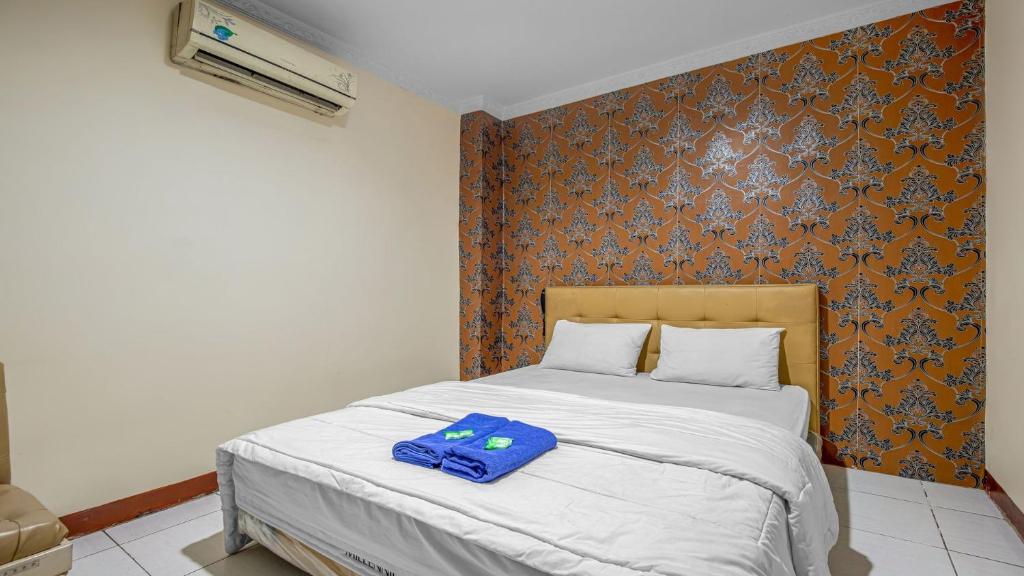 Postel nebo postele na pokoji v ubytování Hotel Cempaka Sari