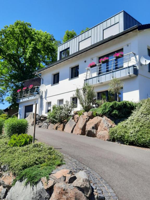 a white building with flowers on the balconies at Kleine Auszeit Eifel in Nettersheim