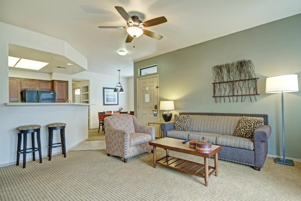 a living room with a couch and a table at Raintree at Phoenix South Mountain Preserve in Phoenix