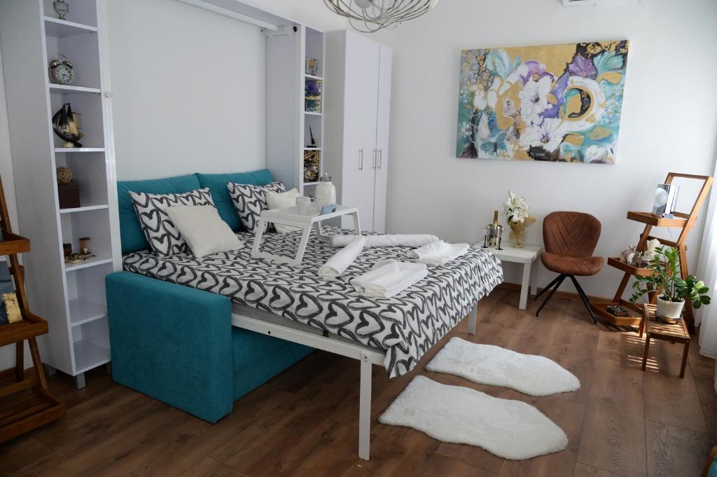 a living room with a blue couch and a rug at Apartment Krins in Novi Sad