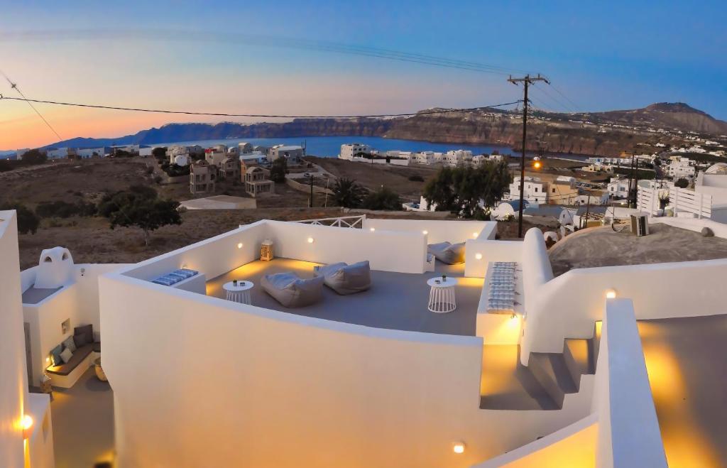 a view from the top of a building at night at Golden Stone Santorini Suites in Akrotiri