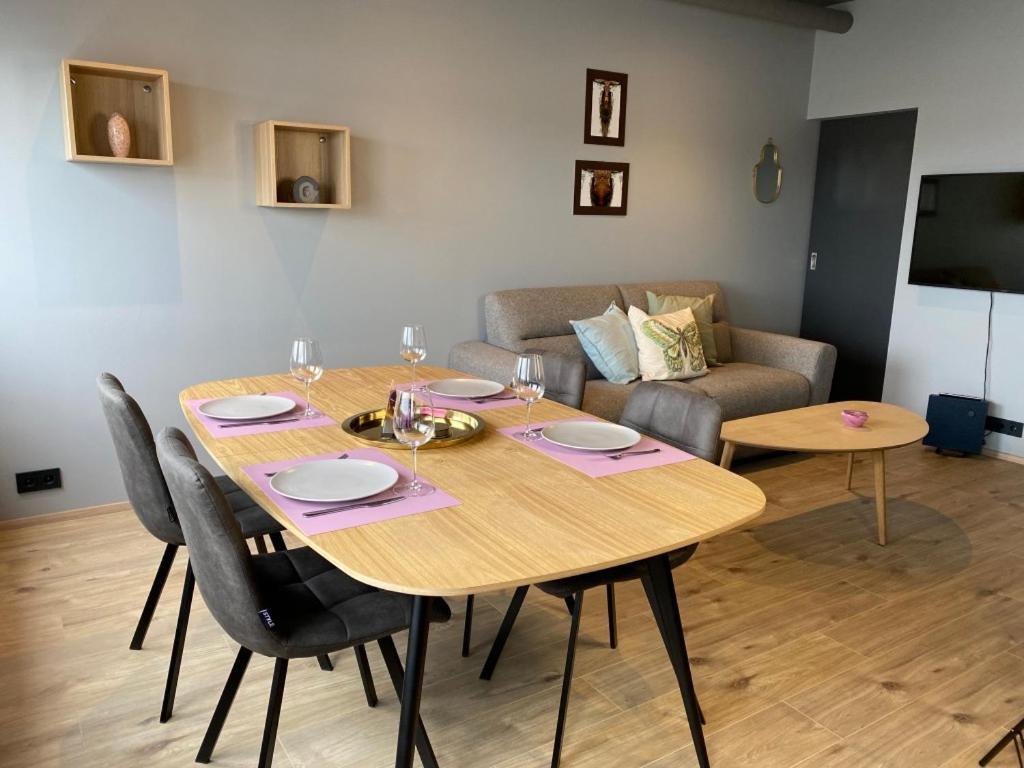 a dining room with a table and a couch at Luxury Loft Apartment Akureyri in Akureyri