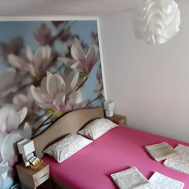 a toy bedroom with a pink bed with pillows at Vicky Apartments in Kotor