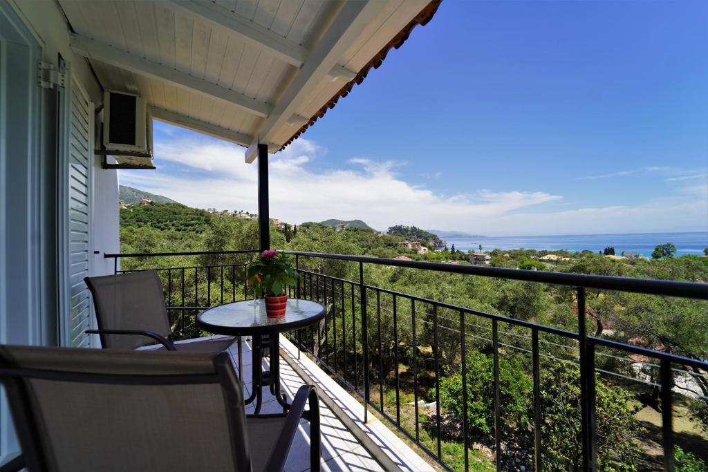 a balcony with a table and a view of the ocean at Meltemi in Parga
