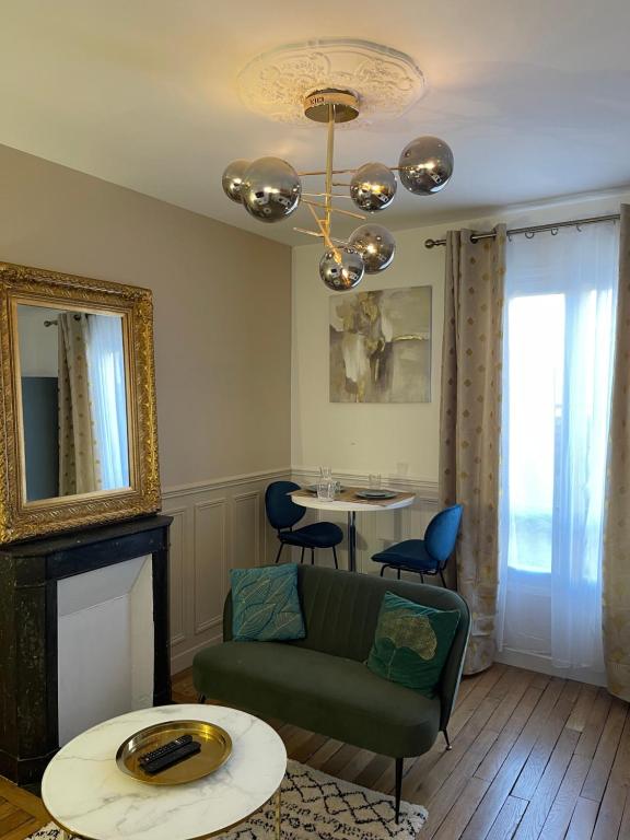 a living room with a couch and a table at Bella Mia - Chic apartment near Orly Rport 15mns frm Paris in Choisy-le-Roi