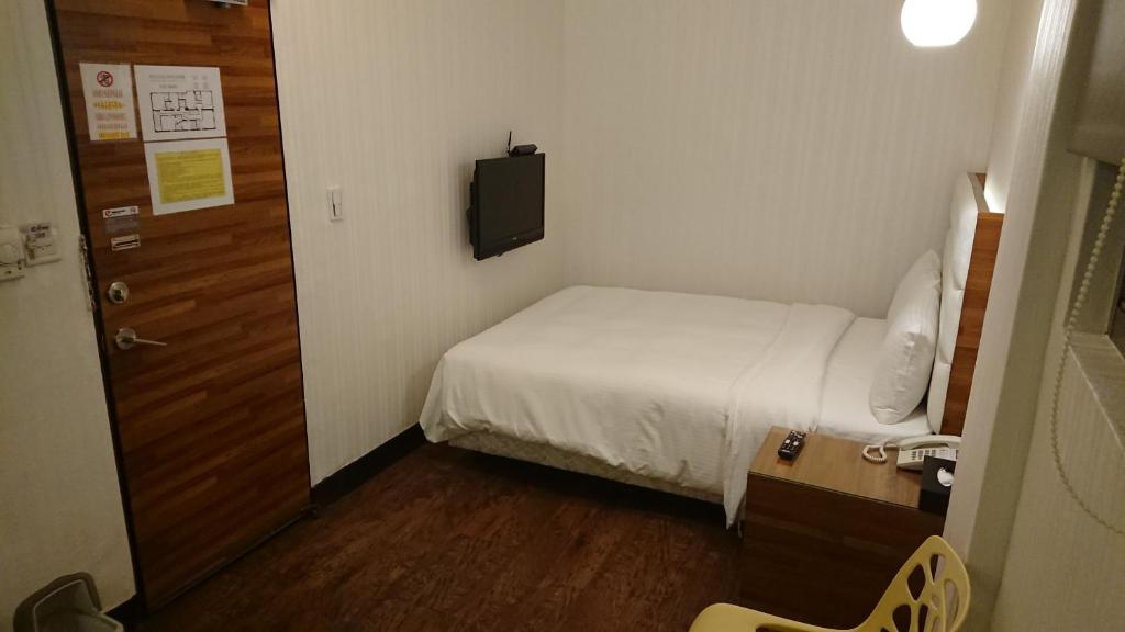 Postel nebo postele na pokoji v ubytování E-Coast Star Hotel