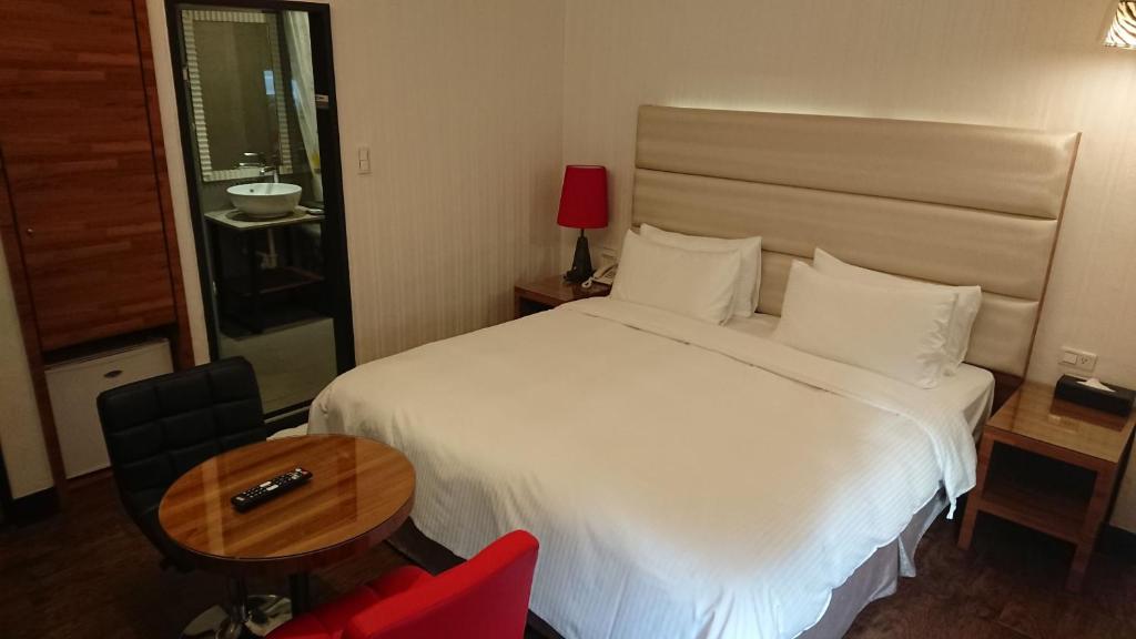 Postel nebo postele na pokoji v ubytování E-Coast Star Hotel