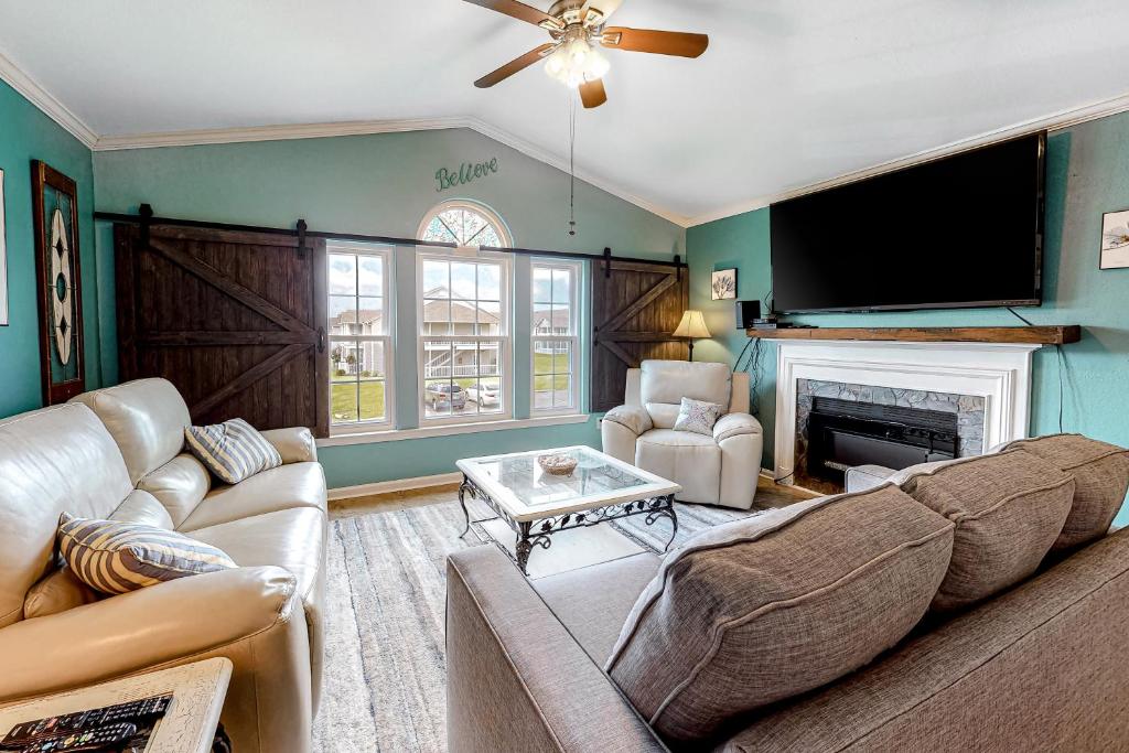 a living room with a couch and a fireplace at Colony Club in Gulf Shores