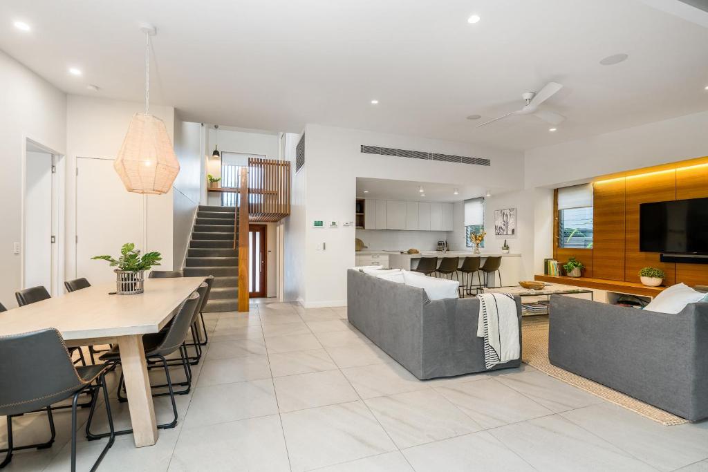 a living room with a couch and a table at Foam in Byron Bay