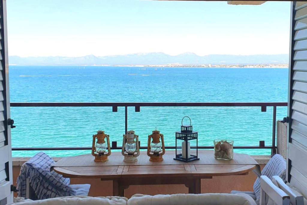 a table on a balcony with a view of the ocean at UHC CANTILMAR in Salou