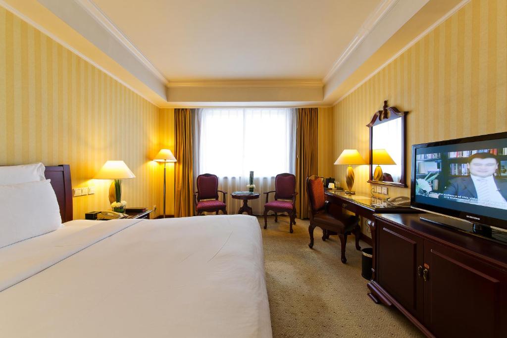 Postel nebo postele na pokoji v ubytování Clarion Hotel Tianjin