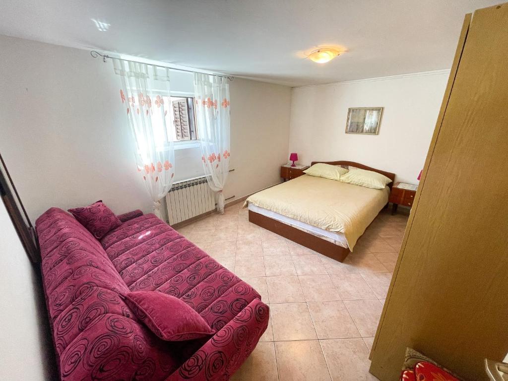 Postel nebo postele na pokoji v ubytování Apartmani Leonarda