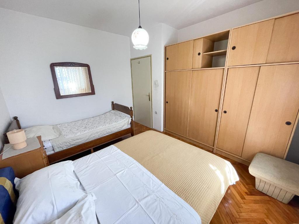 Postel nebo postele na pokoji v ubytování Apartmani Leonarda