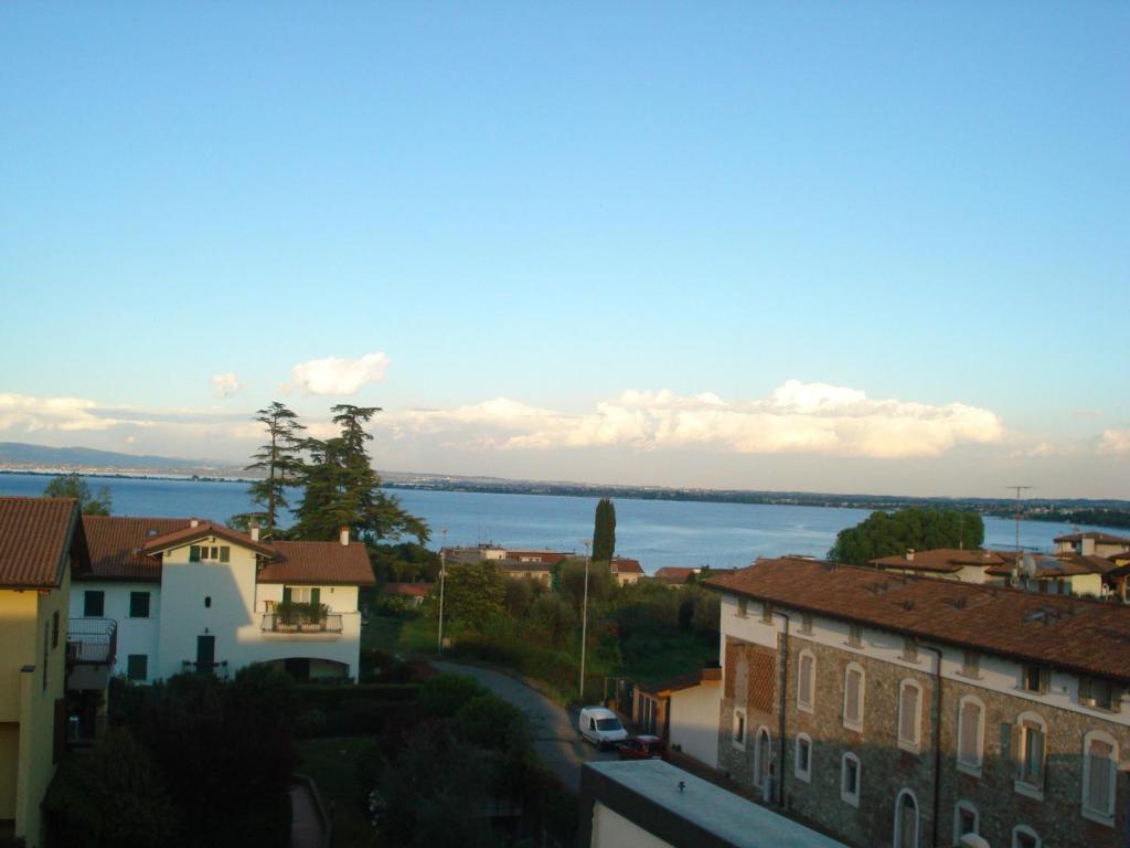 a view of a town with a river and buildings at Appartamento San Benedetto in Desenzano del Garda