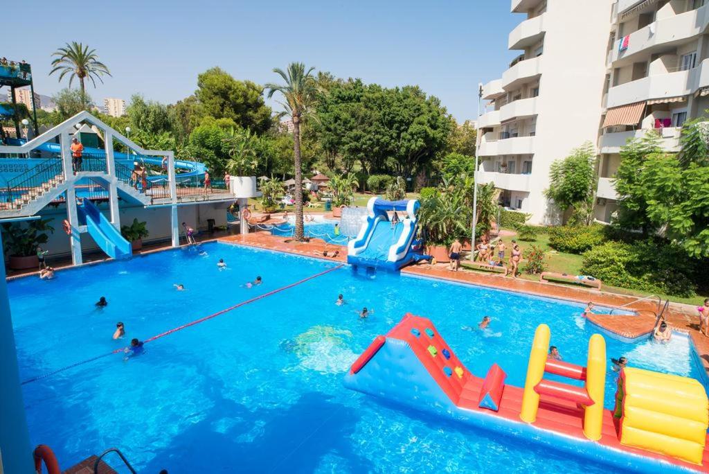 a pool at a resort with people in it at benal beach 81 in Benalmádena