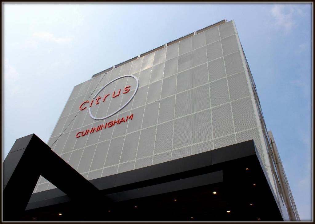 a building with a sign on the side of it at Citrus Hotel Cunningham in Bangalore