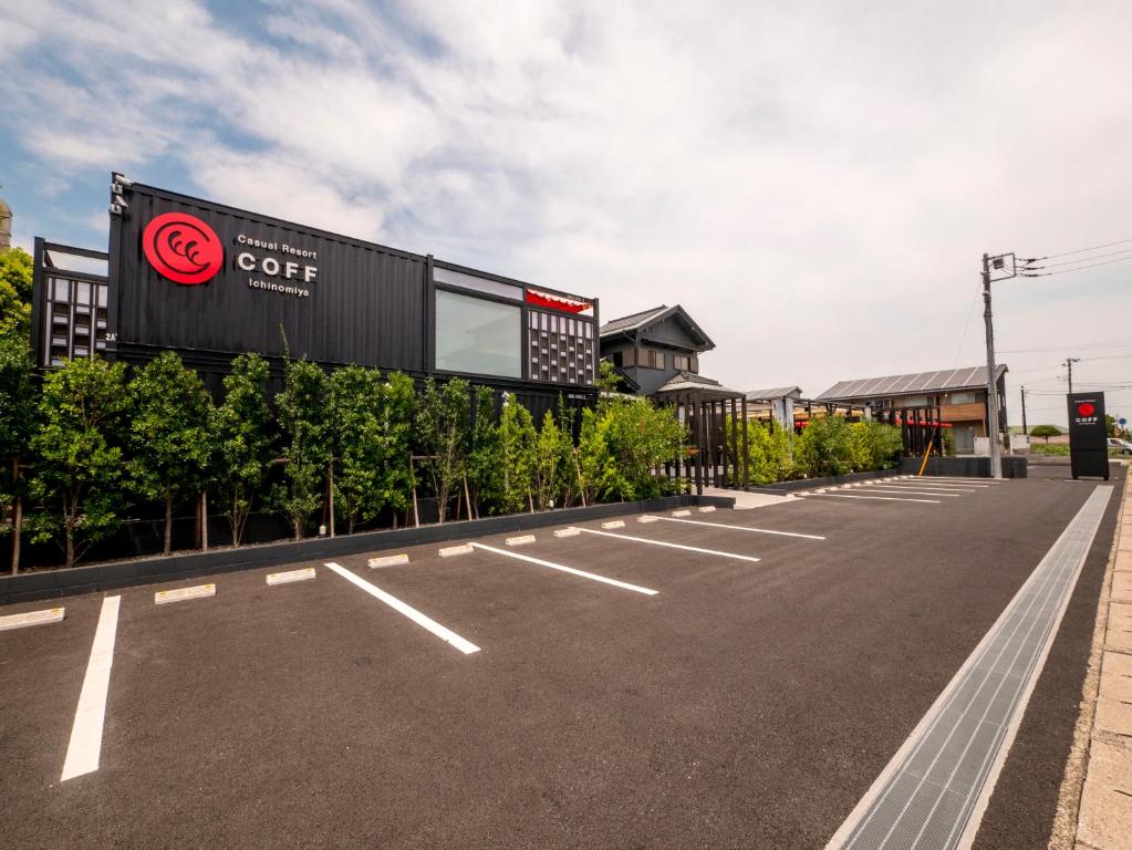 an empty parking lot with a sign for a coffee store at HOTEL R9 Kujukuri "ex Casual Resort COFF Ichinomiya" in Ichinomiya