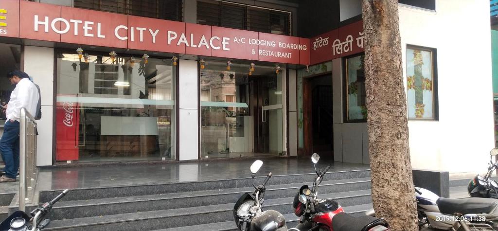 two motorcycles parked in front of a hotel city palace at City Palace Hotel होटल सिटी पैलेस in Nashik