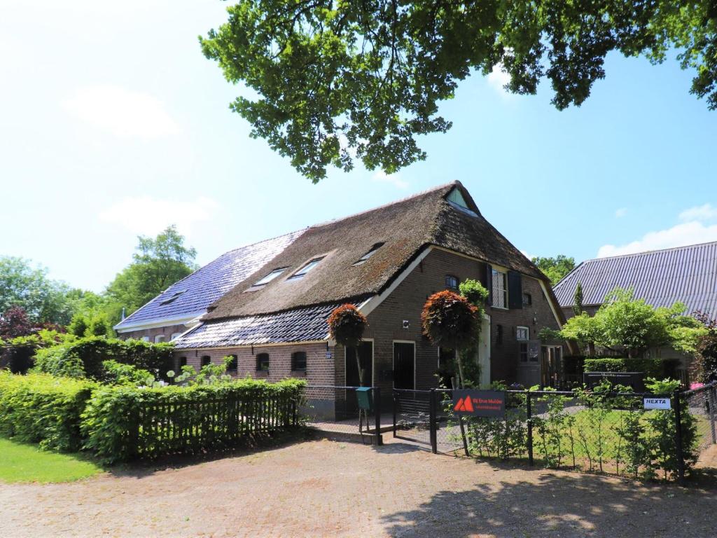 a building with a roof with flowers on it at Modern Saxon farmhouse in Dalerveen village in Dalerveen