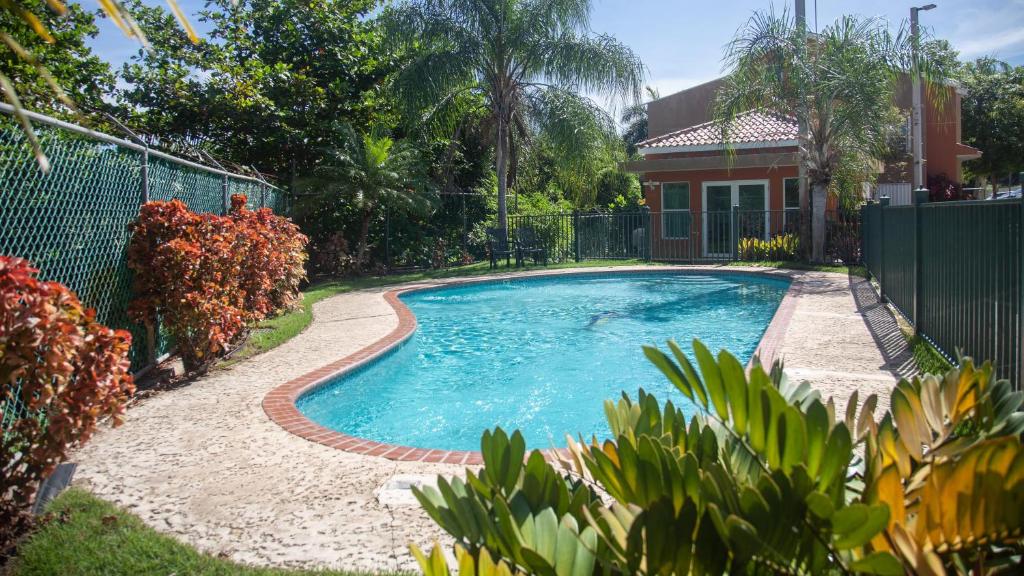 a swimming pool in a yard next to a house at Landing View 204 with private rooftop terrace in Rincon