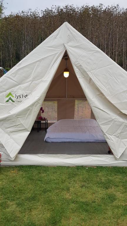 a tent with a mattress in the grass at Lys I dalen resort&camping in Khao Kho