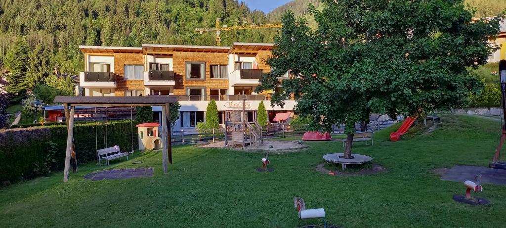 a building with a playground in front of a house at Phantasia in Flachau
