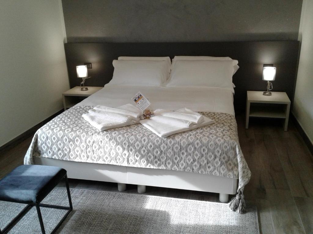 um quarto com uma cama com duas toalhas brancas em Residenza Novi em Novi Ligure