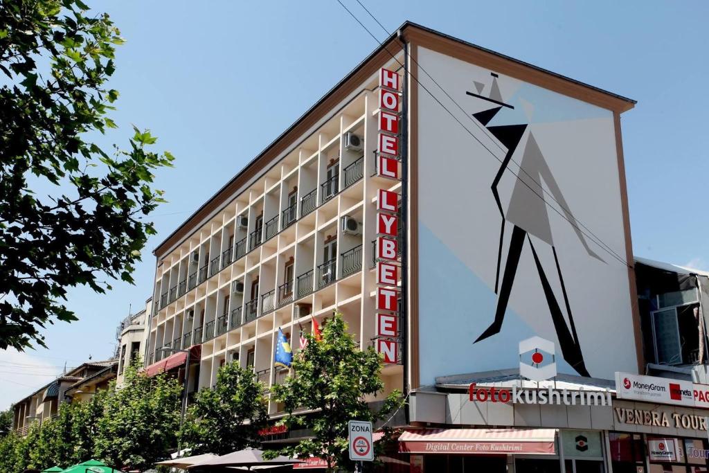 a building with a large sign on the side of it at HOTEL LYBETEN in Ferizaj