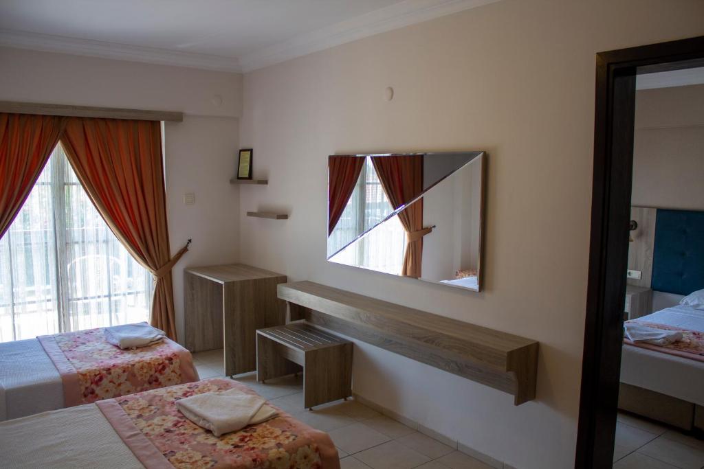 A bed or beds in a room at Hamle Hotel