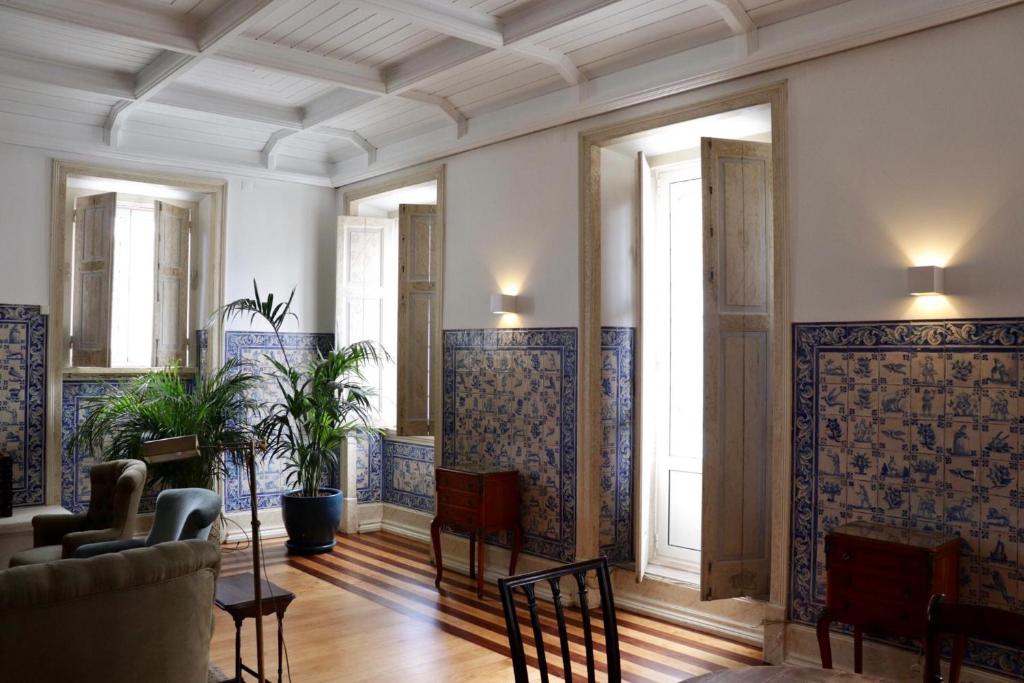 a living room with blue and white tiles on the walls at Pergola Boutique Hotel in Cascais