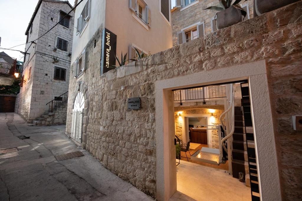 a stone building with a doorway in a street at Camera Hotel in Split