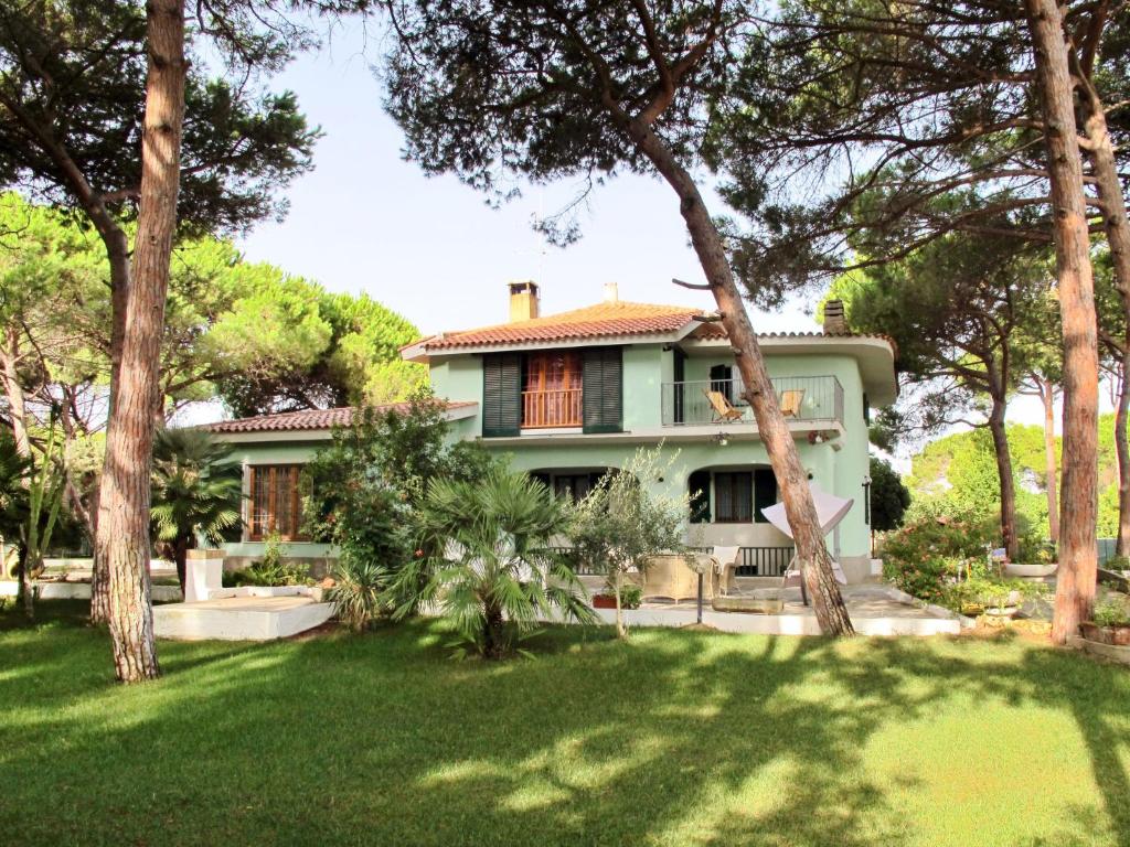 una casa verde con árboles en el patio en Holiday Home Villa Margherita by Interhome, en Platamona