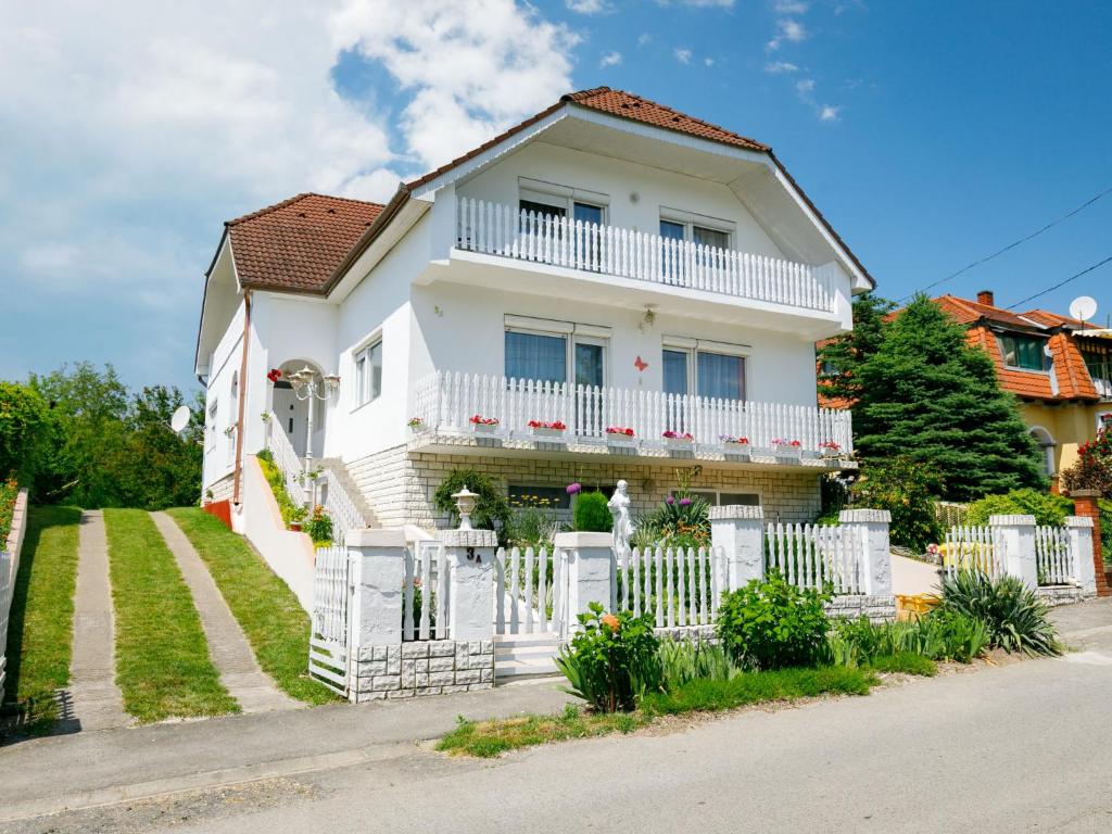 a white house with a white fence at Apartment Casablanca 1 by Interhome in Balatonszemes