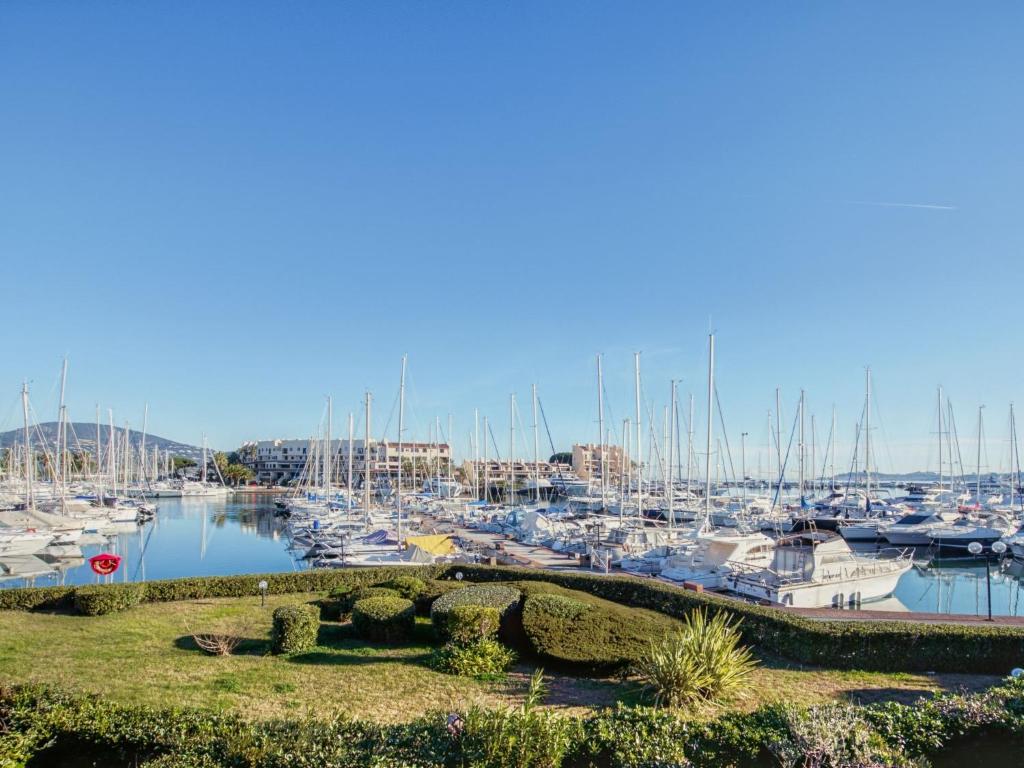 a marina with lots of boats in the water at Apartment Les Deux voiles-1 by Interhome in La Foux