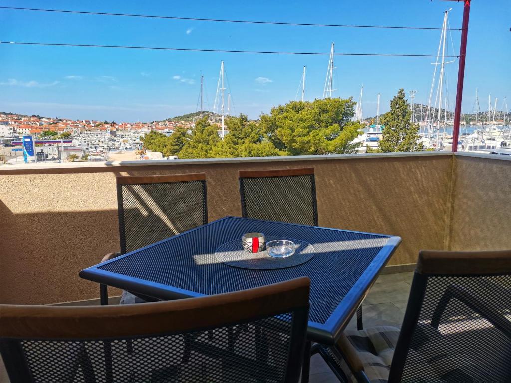 einen blauen Tisch und Stühle auf einem Balkon mit Aussicht in der Unterkunft Apartment Hramina in Murter