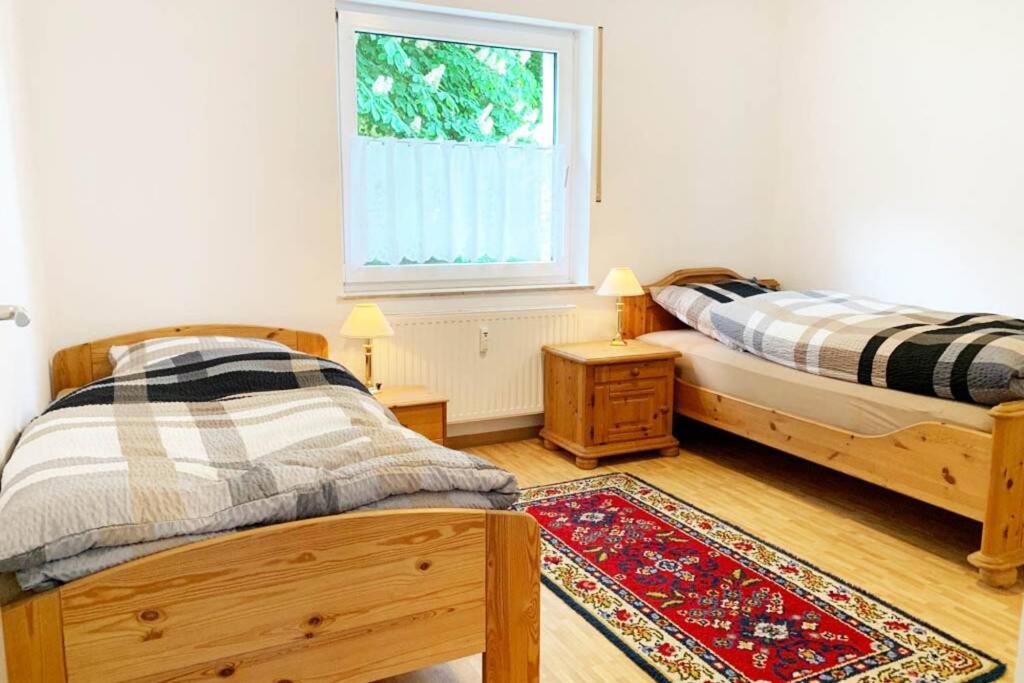 1 dormitorio con 2 camas y ventana en Gemütliche Wohnung in Siegen en Siegen